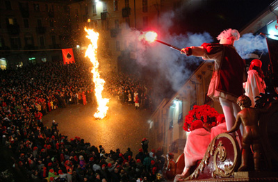 Lo Scarlo è il palo rivestito di erica e ginepro bruciato il Martedì Grasso in ogni quartiere: sono simbolo di buon augurio per Ivrea, dono del Carnevale che finisce